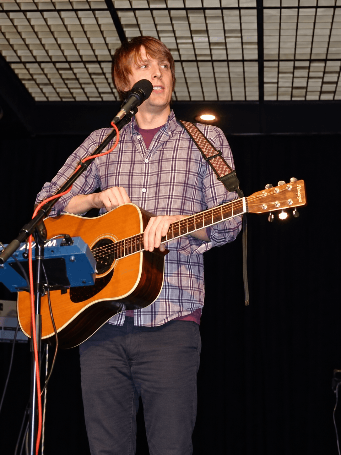 Eric Hutchinson singing and playing acoustic guitar