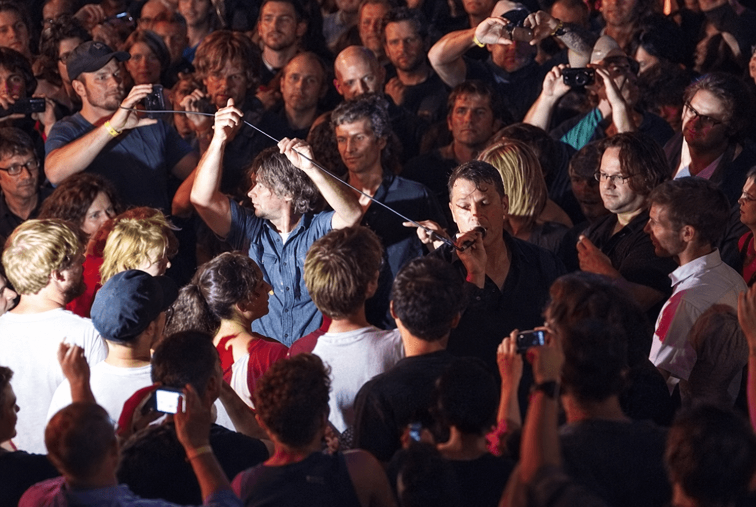 Greg Dulli of The Afghan Whigs singing among the crowd at a Lollapalooza aftershow